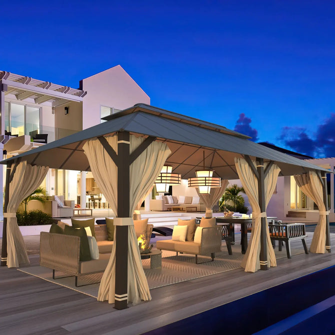 Erommy aluminum gazebo with a double roof, tied curtains, lounge seating, dining area, and pendant lighting on a modern outdoor deck at dusk