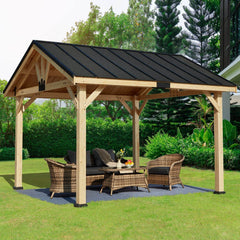 Erommy wood gazebo with a dark asphalt roof, open sides, and wicker seating on a patio in a lush garden.setting