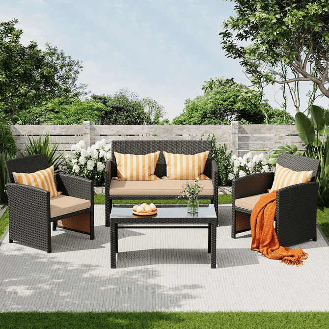 Outdoor patio set with chairs, sofa, and table in a garden setting